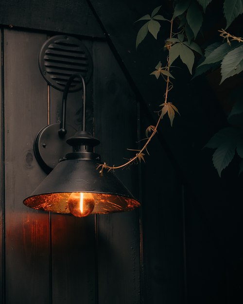 Warm lamp detail inside a wooden cabin interior