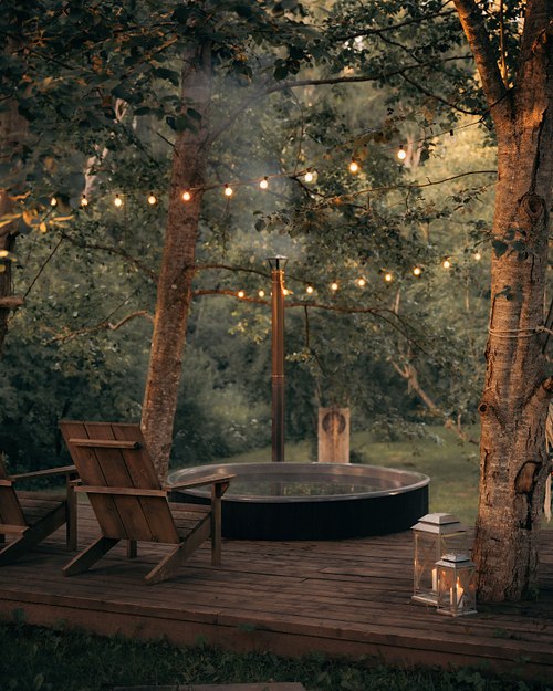 Wooden hot tub and forest terrace at Two Black Cabins