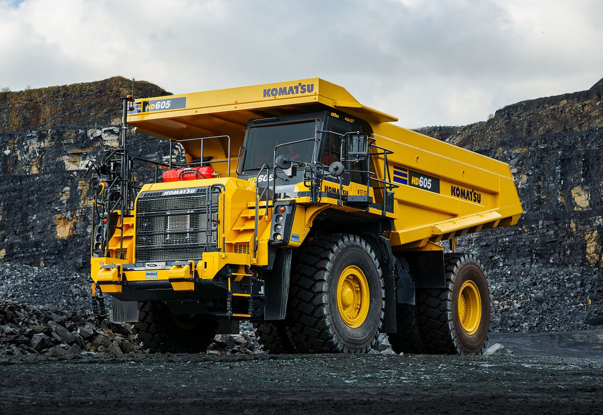 Detailed view of a Komatsu HD605 dump truck in a Roadstone quarry setting