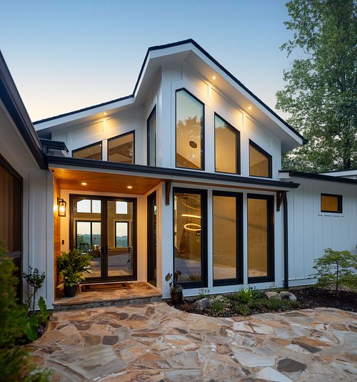A close up of the full glass wall gabled entry that opens up into the family's great room and monumental stair.