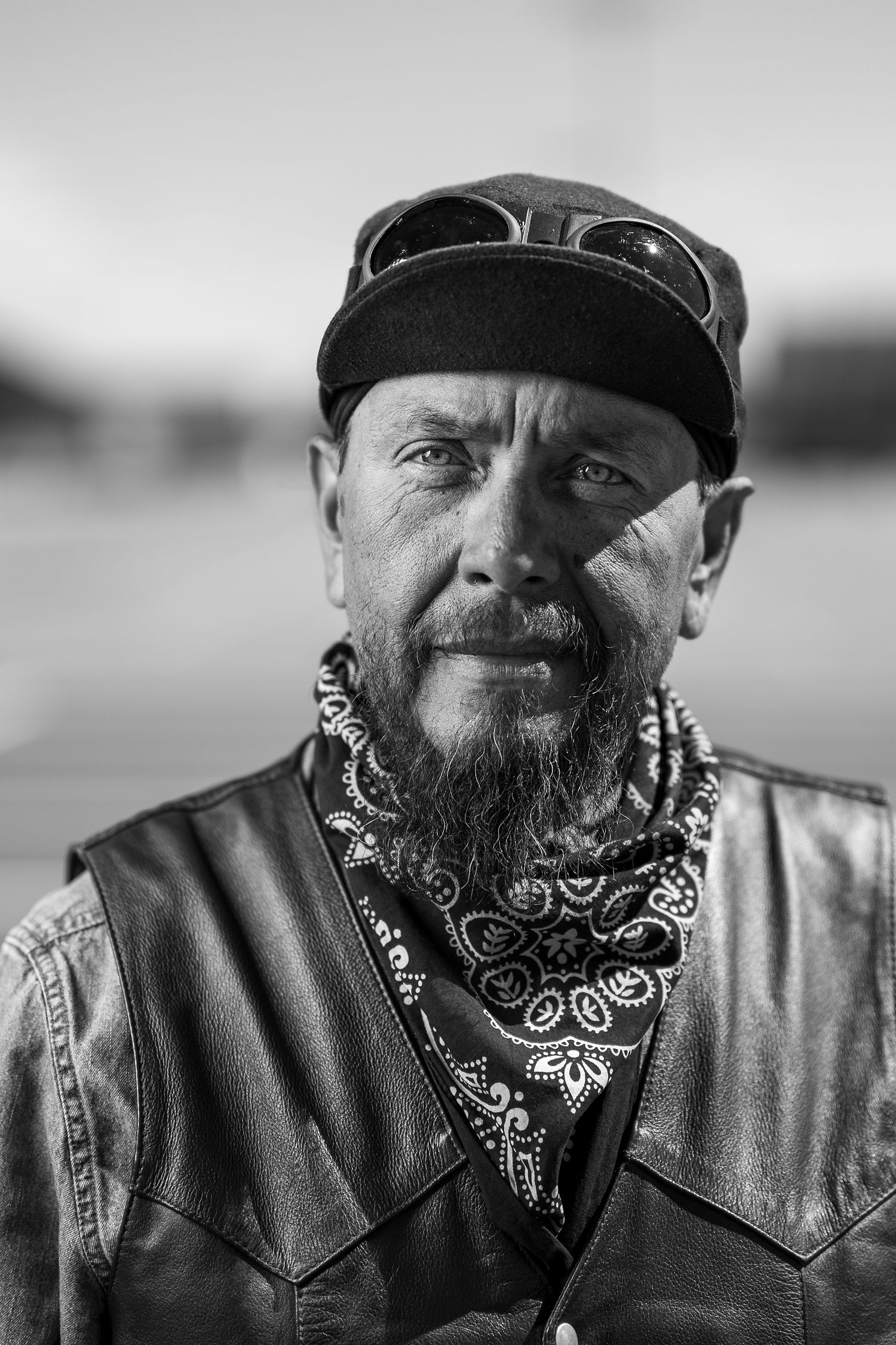 Portrait of older man, black and white, motorcycle clothing, editorial