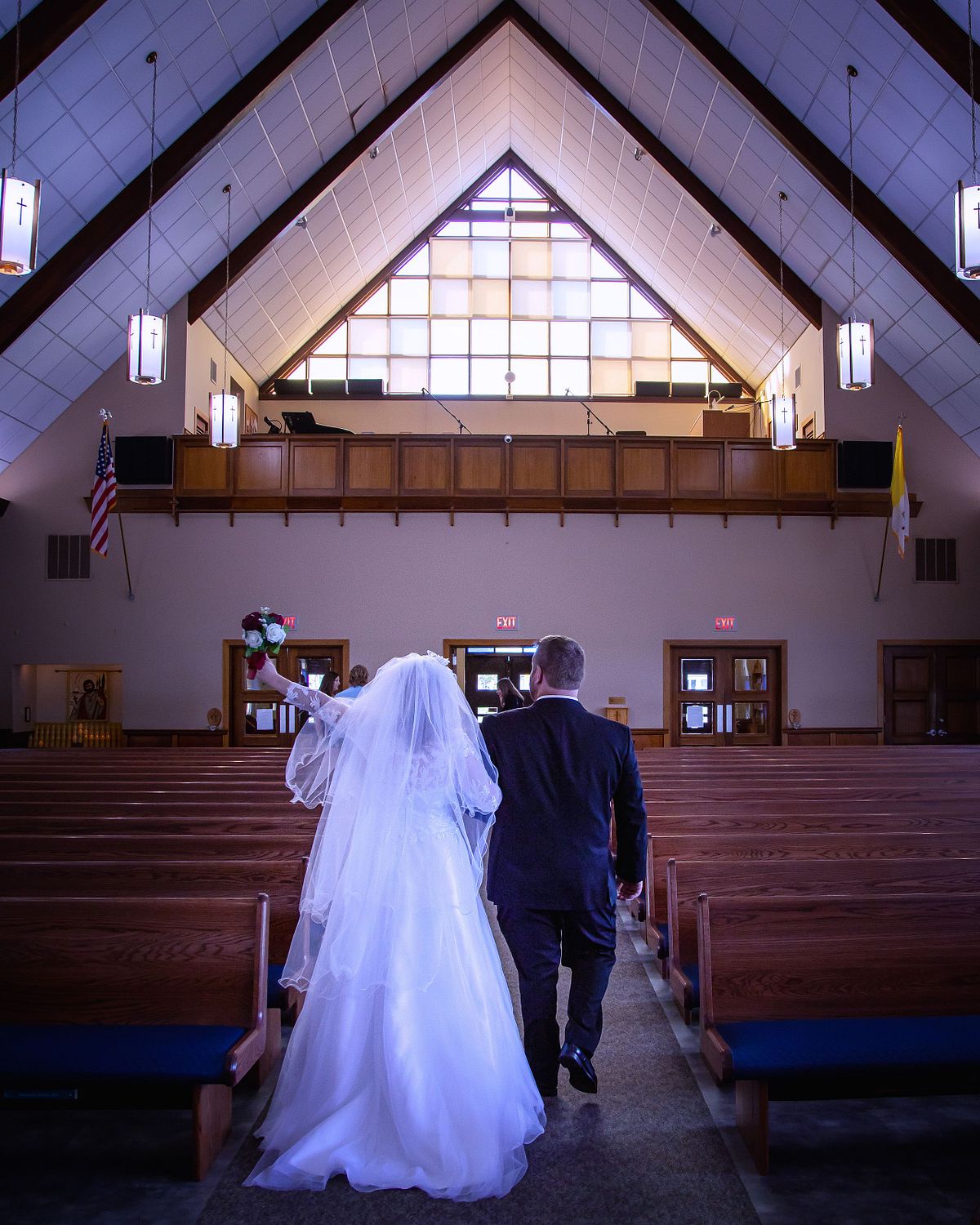 bride and groom walking down the aisle after wedding ceremony at st. lukes in lewes, delaware