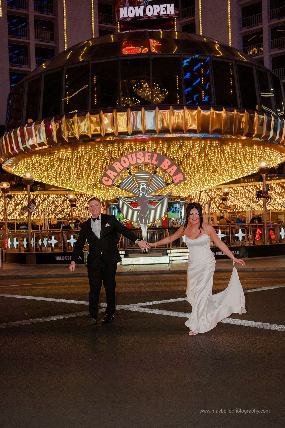Romantic elopement photos at Carousel Bar in Downtown Las Vegas with couple celebrating with champagne