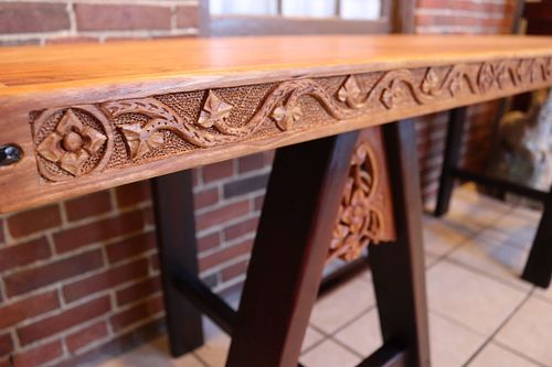 carving on skirt of cherry trestle table