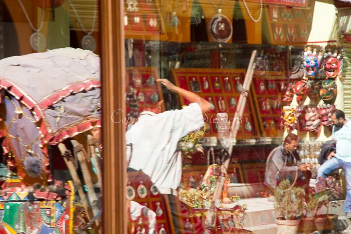 A rickshaw weaving through the bustling Durbar Square, reflecting the lively essence of Kathmandu.