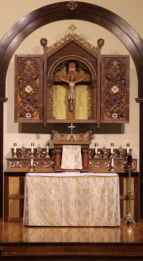 Hand carved altarpiece at St. Bernadette Catholic Church in Lancaster, Ohio.  Covered with intricate carvings of birds, vines, and flowers.