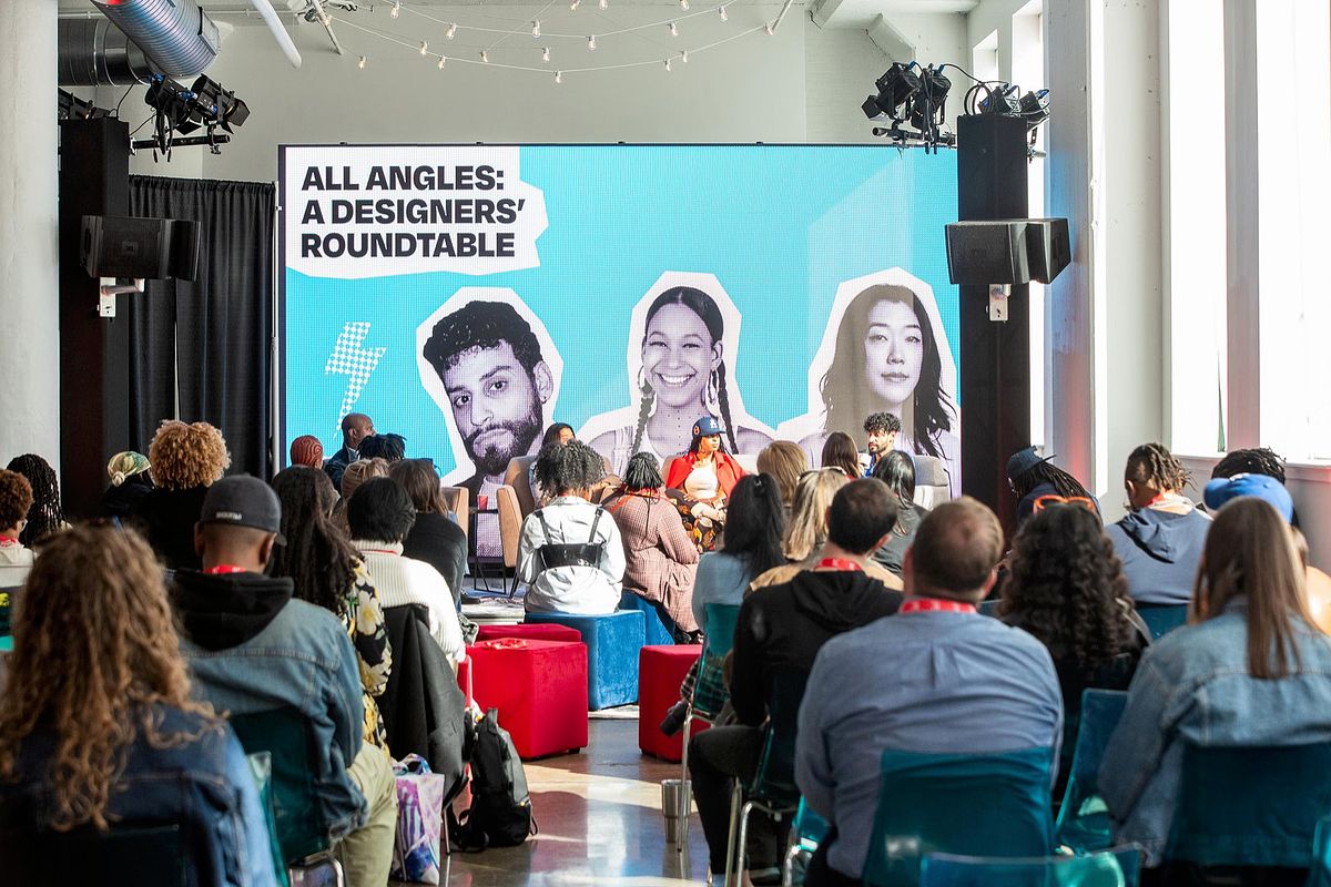 Corporate event photography capturing creative leaders speaking during the &ldquo;All Angles: A Designers&rsquo; Roundtable&rdquo; session at B.PHL Fest 2023 in Philadelphia, emphasizing innovation, collaborative storytelling, and the exchange of ideas in design.
