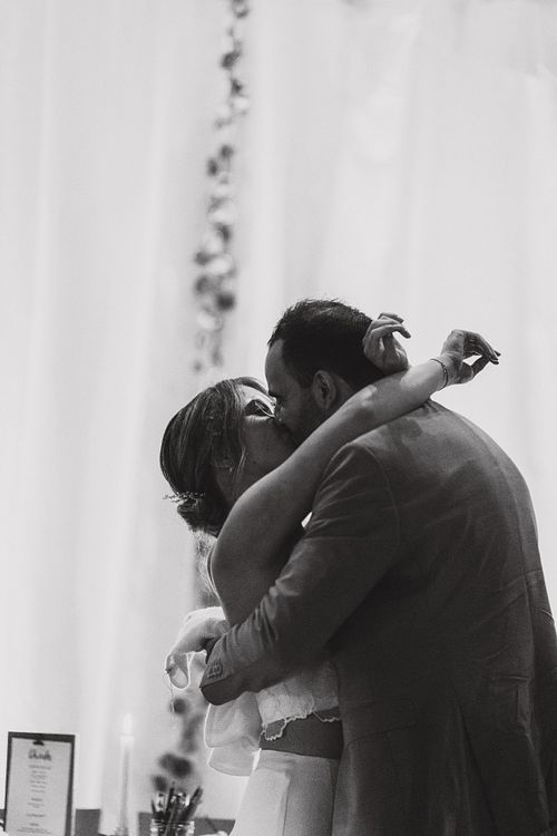 couple captured kissing at wedding