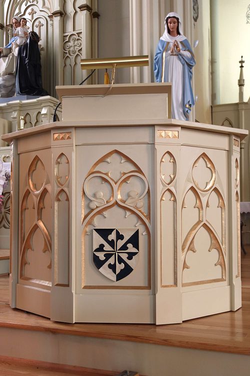 Gothic Revival Ambo carved with a prominent Dominican Shield for Holy Trinity Catholic Church in Somerset, Ohio.