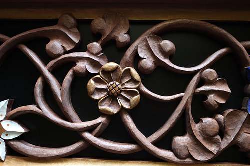 hand-carved wild rose with gold paint