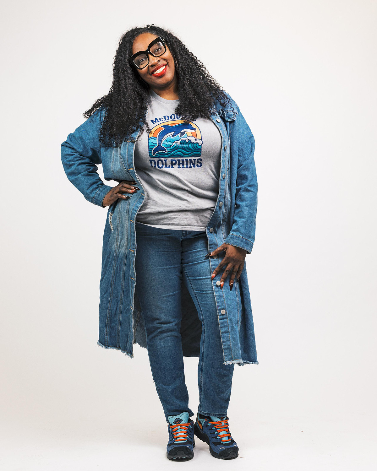 Principal Jones of McDougle Elementary School posing confidently in a denim jacket and glasses during a studio portrait session in Carrboro NC.