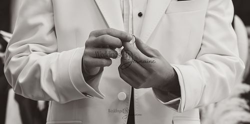 Wedding by Jermaine – black and white close-up of the groom holding the wedding ring