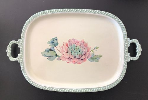 Decorative tray with floral design and handles, featuring soft pink flowers.